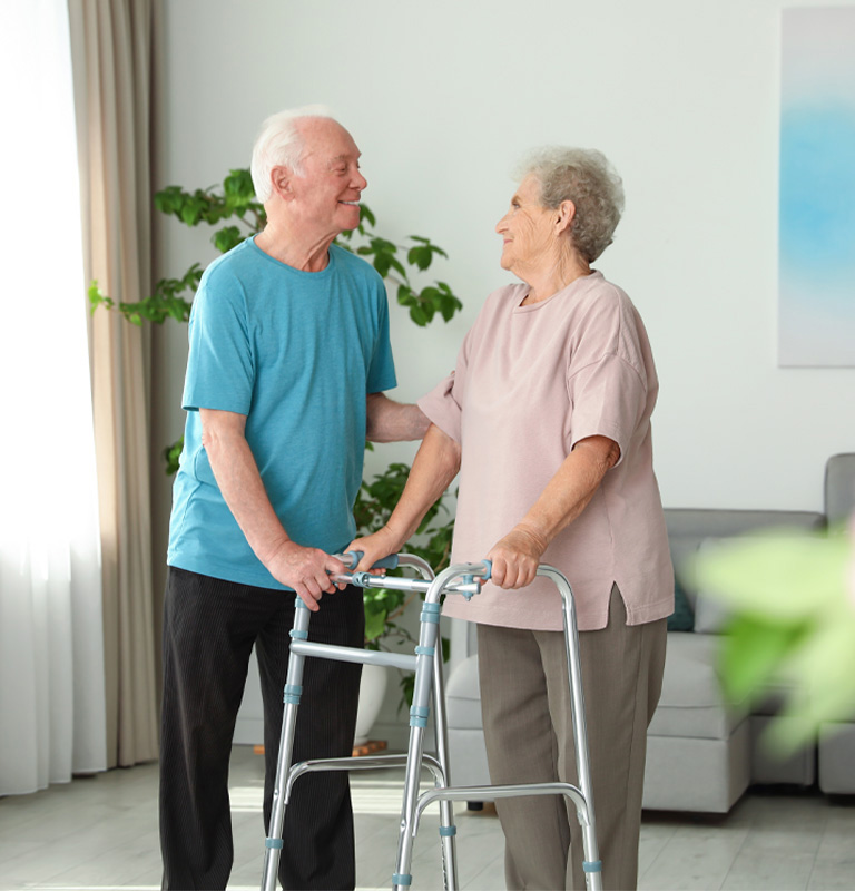 Lady and man walking using walking assistance