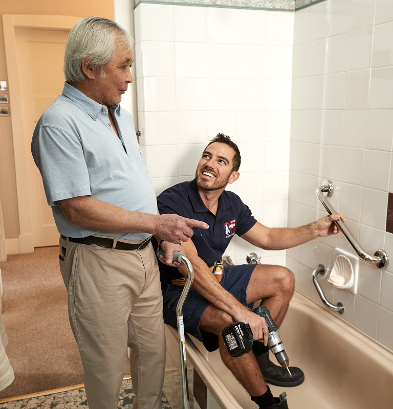 Man helping make changes to elderly mans shower