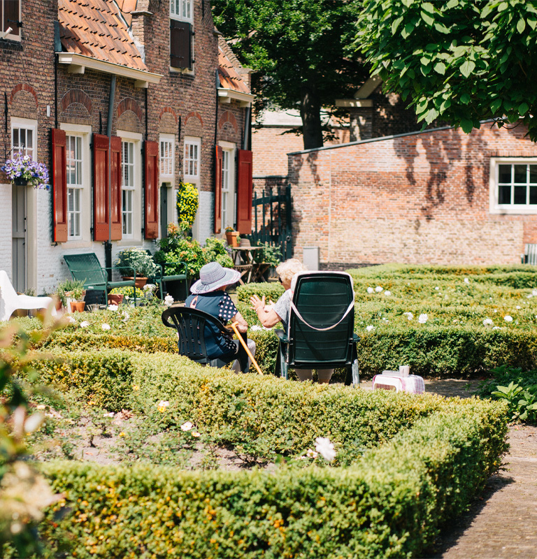 Two elderly ladies sitting in the garden