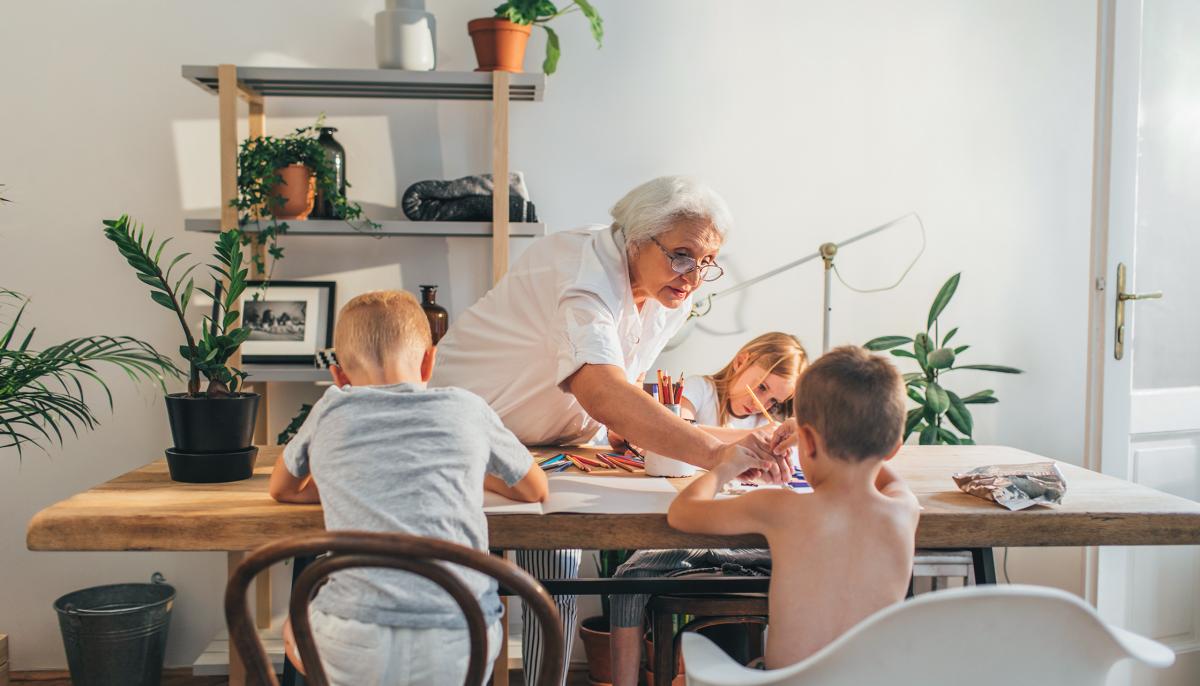 Woman at table with grandchildren