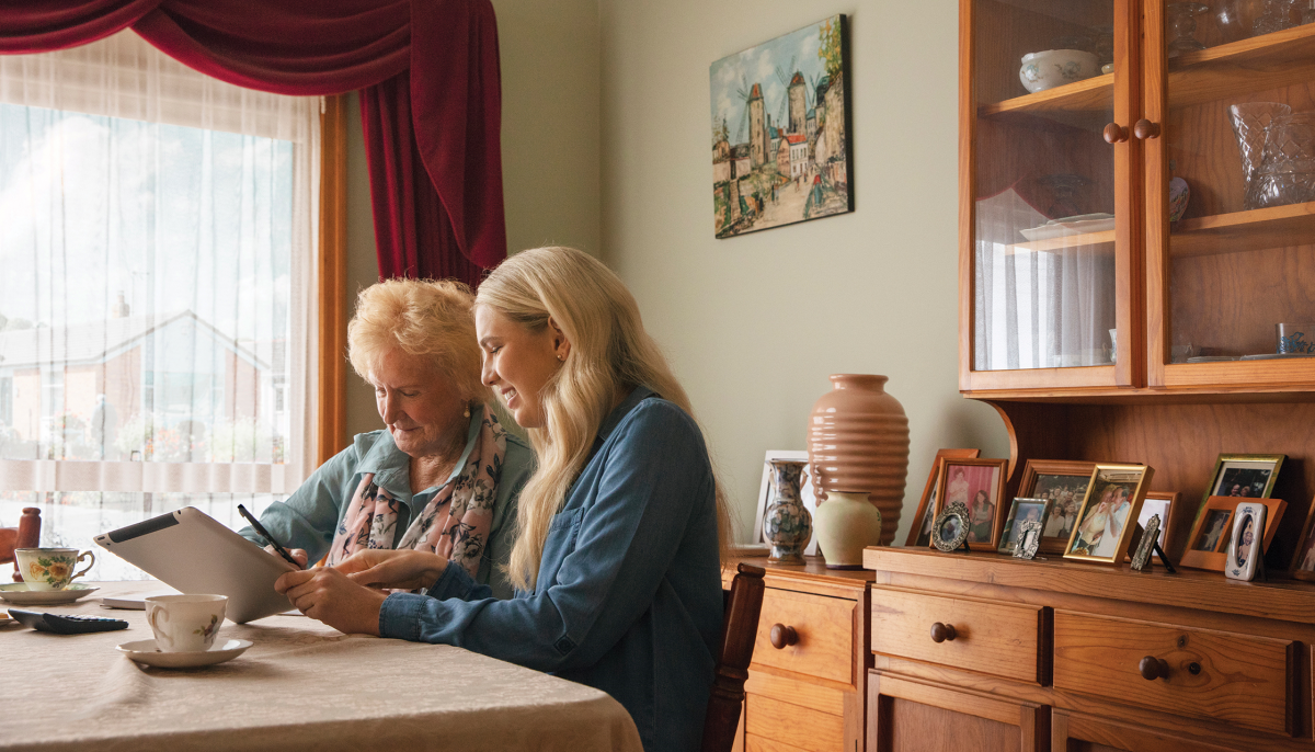 Younger woman and older woman chatting at table