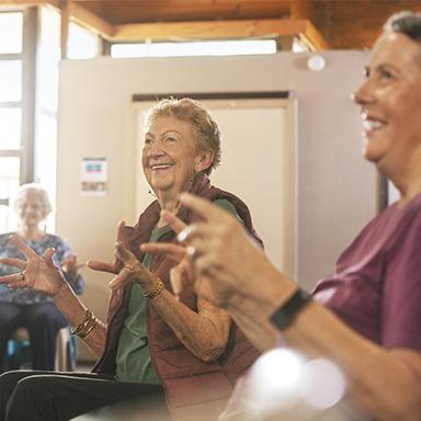 Image shows older persons enjoying an activity in a aged care facility