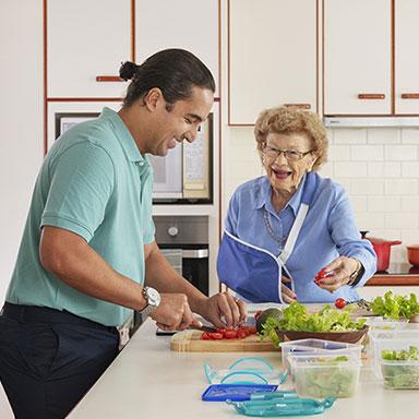 Support person cooking for an older Australian